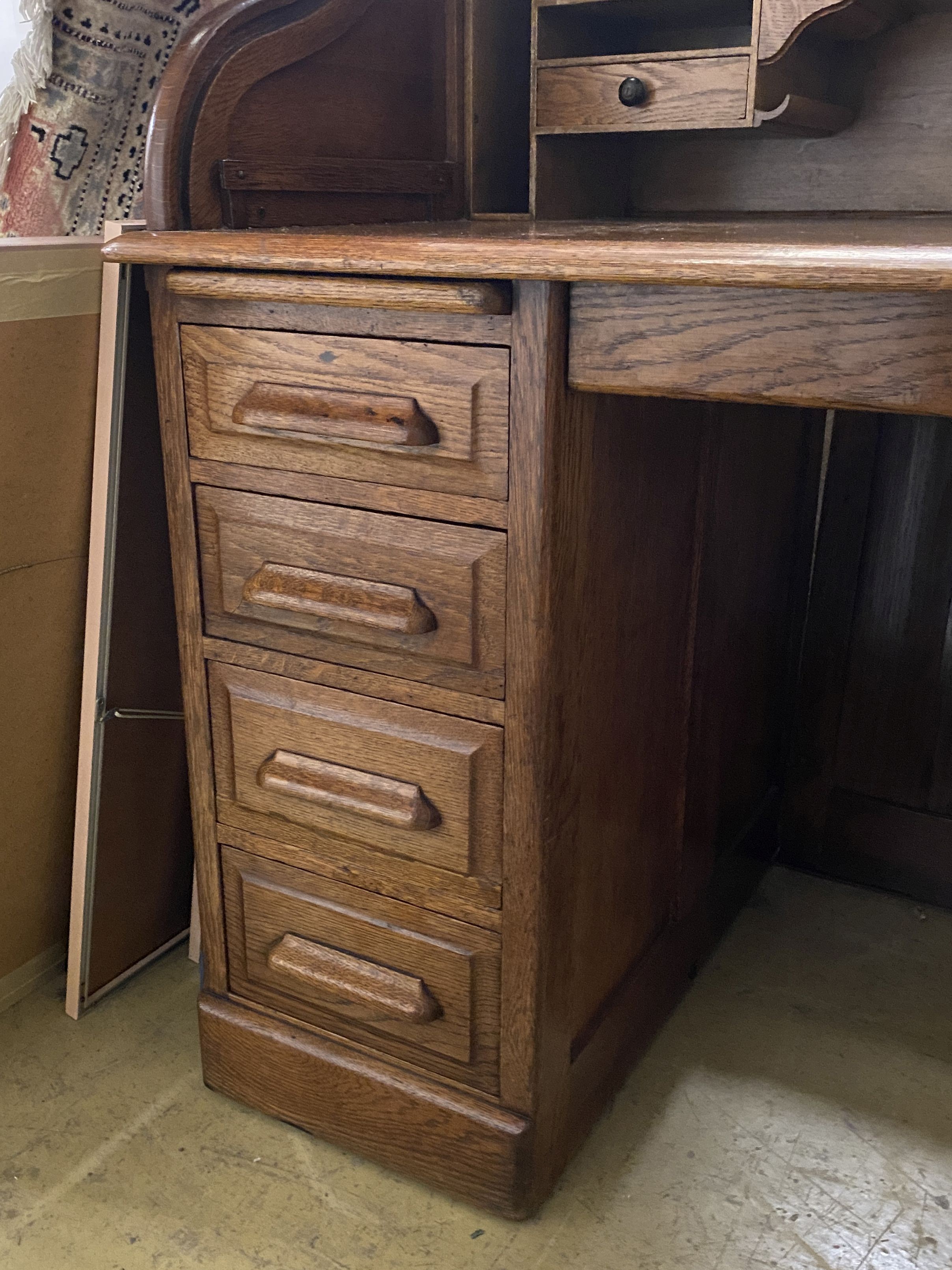 An early 20th century oak roll top desk with 'S' shaped tambour, width 122cm, depth 78cm, height 124cm